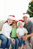 Adorable family at Christmas sitting in the living-room