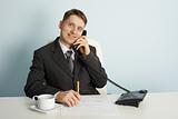 Smiling businessman in talks on phone