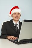 Man in festive Christmas mood with laptop