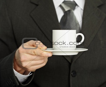 Coffee cup in hand, a businessman - need a break