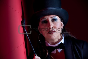 Woman with whip wearing a top hat