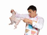 Handsome young man holding chicken preparing to cook