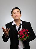 Happy romantic husband holding rose flower and vine bottle