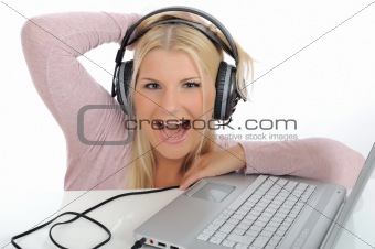 Pretty girl listening and singing to the music with headphones