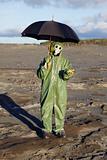 Person with umbrella waits radioactive rain