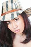 Young Asian woman in hat