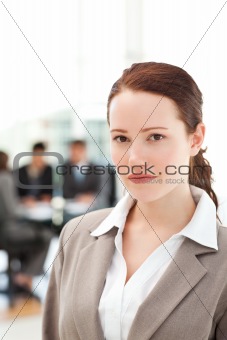 Serious businesswoman standing during a meeting with her team