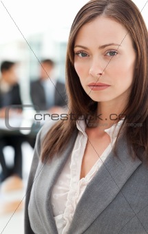 Charismatic businesswoman in the foreground while her colleagues