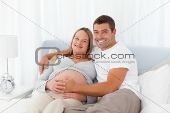 Cute couple resting together on a bed