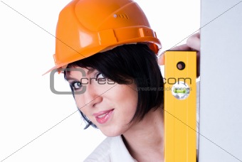 Woman in helmet with level