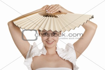 Young woman holds fan over head