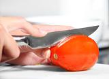 Cutting red tomato