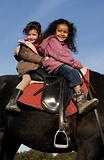 two riding little girls