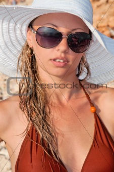 beautiful woman in a hat and sunglasses