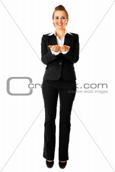 Full length portrait of smiling modern business woman presenting something on empty hands
