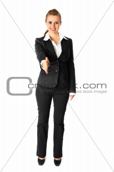 Full length portrait of smiling modern business woman stretches out hand for handshake

