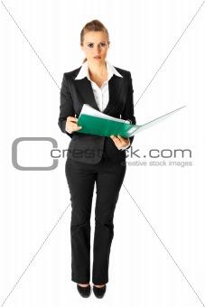 Full length portrait  of thoughtful modern business woman holding folders  with documents in hands
