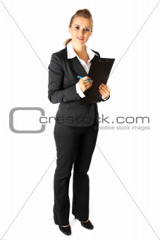 Full length portrait of attentive modern business woman with clipboard and pen
