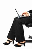 Business woman sitting on chair and using laptop.  Close-up.
