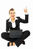 Smiling modern business woman got  idea while sitting on floor with  laptop
