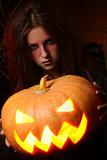 beautiful woman witha pumpkin in the hands