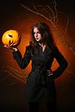 beautiful woman with a pumpkin in the hands