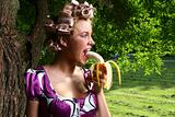 beautiful young woman eating banan