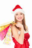 Pretty girl in a red Christmas hat with colorful bags