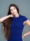 beautiful woman in blue dress with long brown hair - isolated on gray