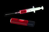 Syringe and medical test tube with bloodon black background