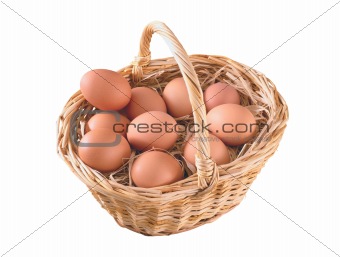 Group of brown hen's eggs in the braided basket isolated on whit
