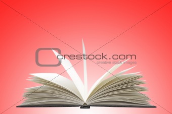 White opened book on red background