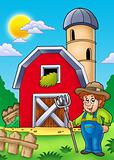 Big red barn with farmer