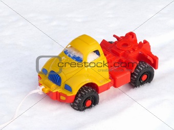 Children's plastic machine on snow 