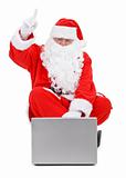 Surprised Santa claus and laptop on white