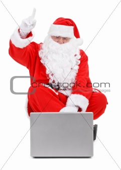 Surprised Santa claus and laptop on white