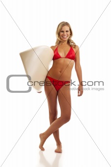 Young woman holding surfboard