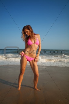 young girl in swimsuit on beach