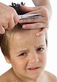 Little boy suffering during his haircut