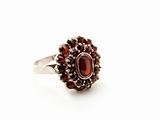 Silver ring with garnet isolated on a white background 