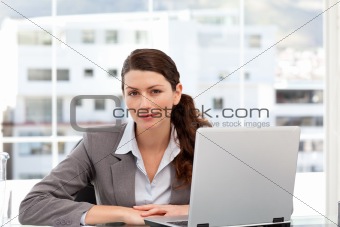 Businesswoman on the computer looking at the camera