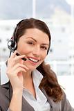 Beautiful businesswoman with headphones and smiling at the camera