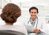 Cheerful hispanic doctor dring an appointment with a patient