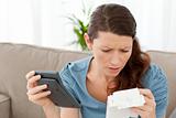 Worried woman calculating her bills in the living-room