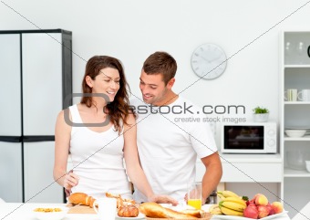 Lovely couple preparing their breakfast together