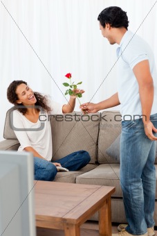 Adorable man giving a rose to his lovely girlfriend 