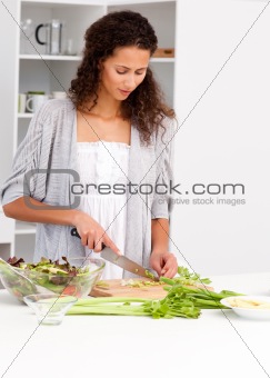Lovely woman cutting vegetables in the kitchen
