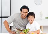 Portrait of a cute boy with his father in the kitchen