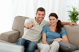 Happy man watching television with his girlfriend 