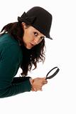 young woman with magnifier glass and hat looking to camera isolated on white background